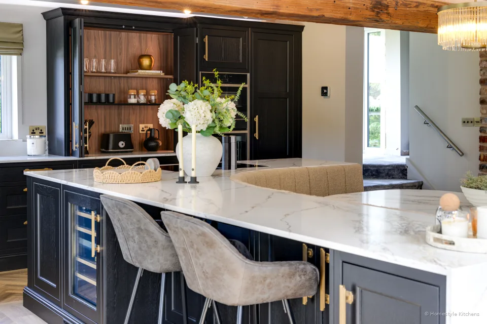 Charcoal island with white quartz, Caple wine cooler and open timber display shelving.
