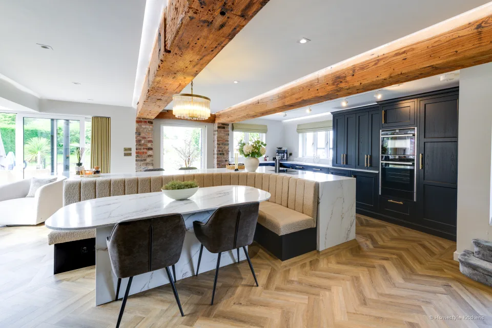 Open-plan charcoal Shaker kitchen and dining, white quartz island and built-in ovens.