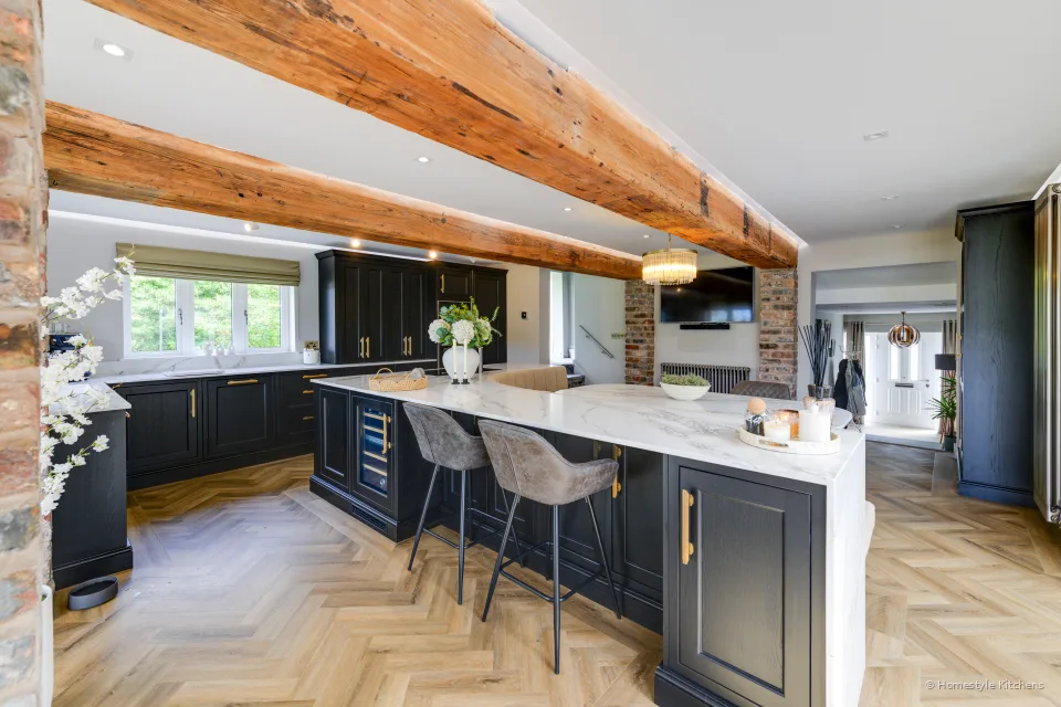 Charcoal Shaker kitchen angled to a white quartz island with a black induction hob.