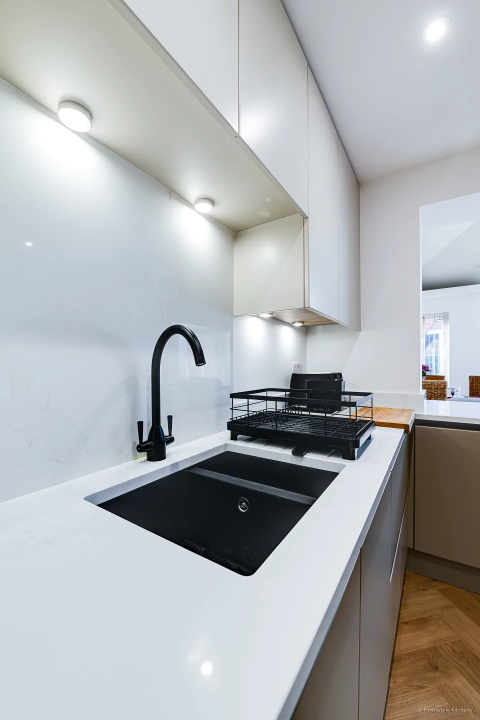 Black Como 1.5-bowl undermount and Danti tap in white quartz.