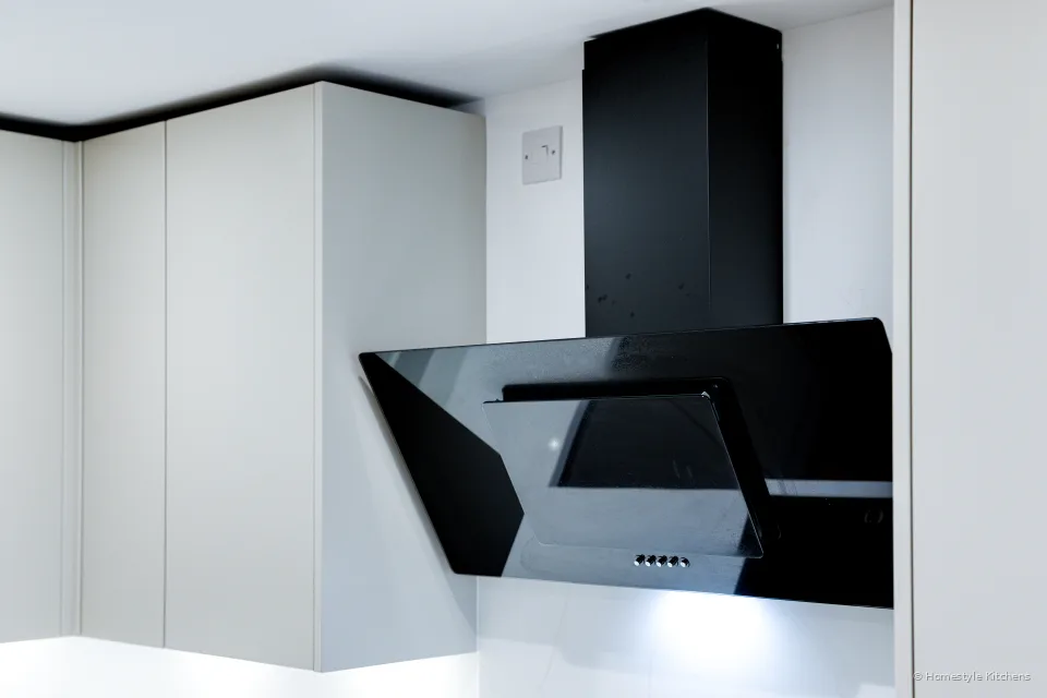 Close-up of the black glass angled extractor above the hob.