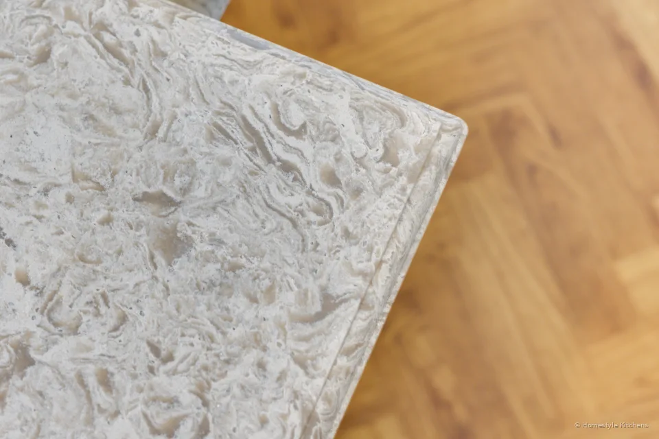 Itastone Mountain White quartz worktop corner with a New York edge, herringbone floor below.