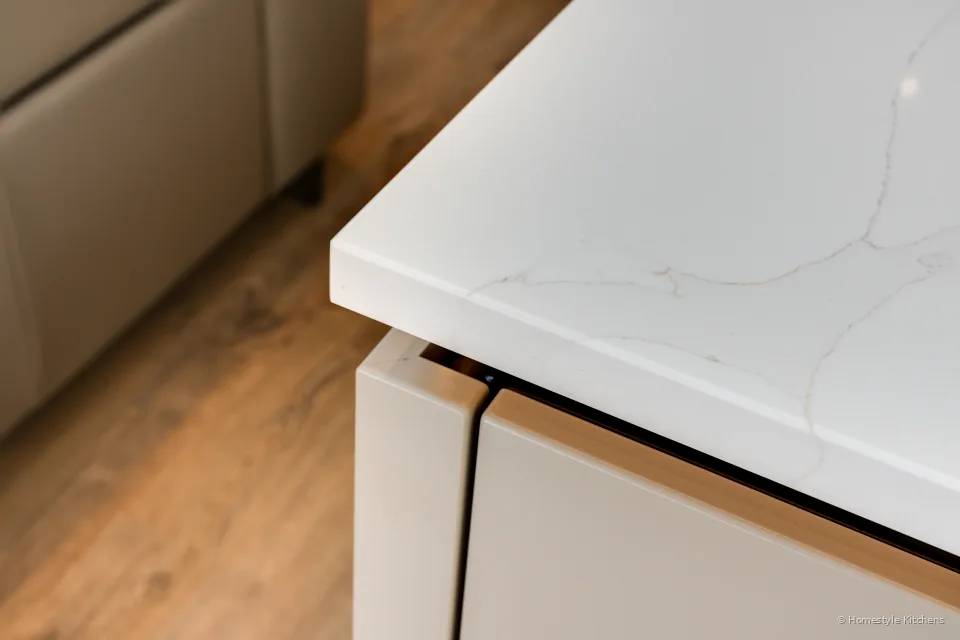 Island end panel and quartz worktop edge.