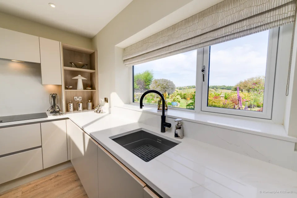 Black Caple sink and Quooker Flex in black under a window, white quartz.