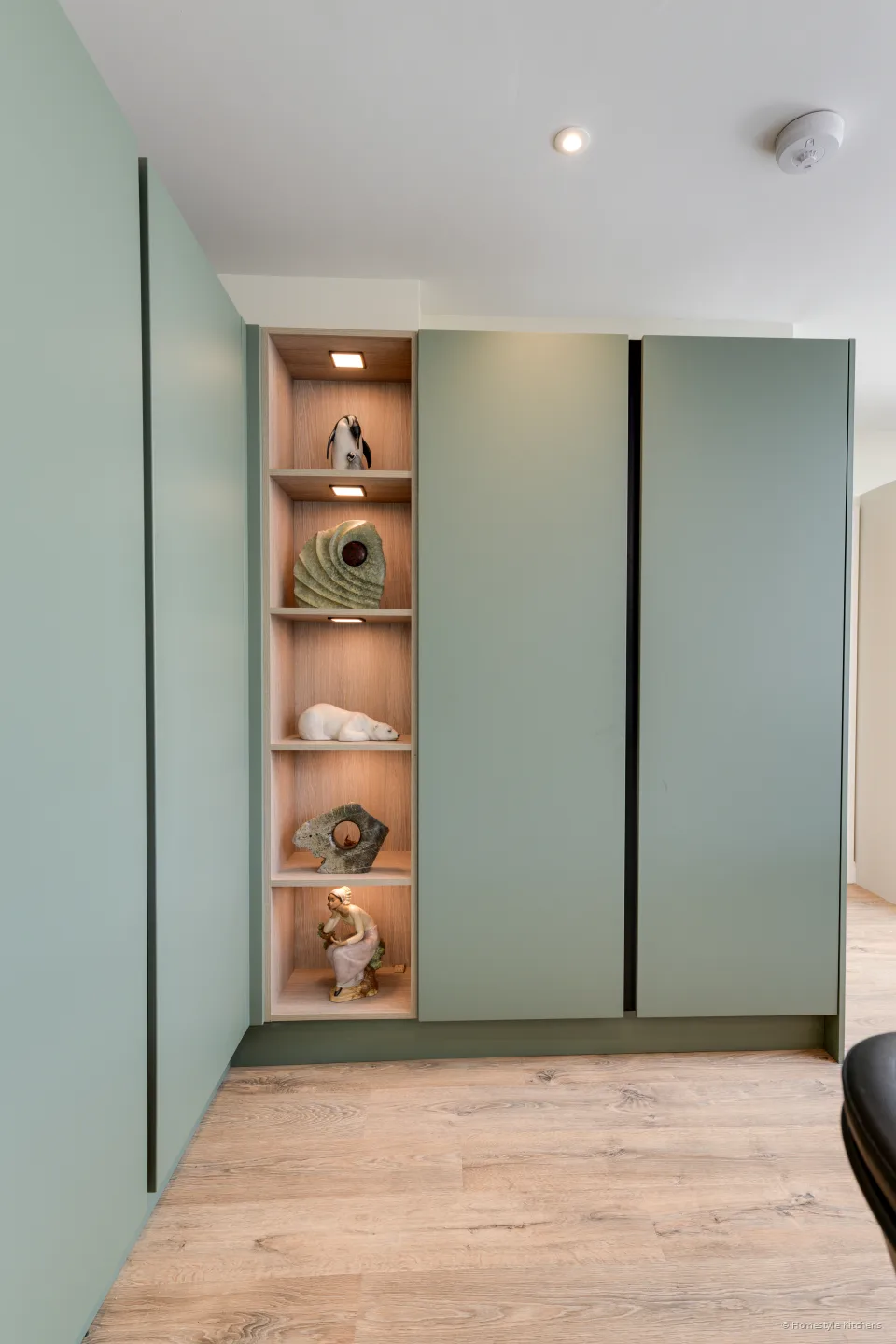 Reed green tall units with an open oak display niche.