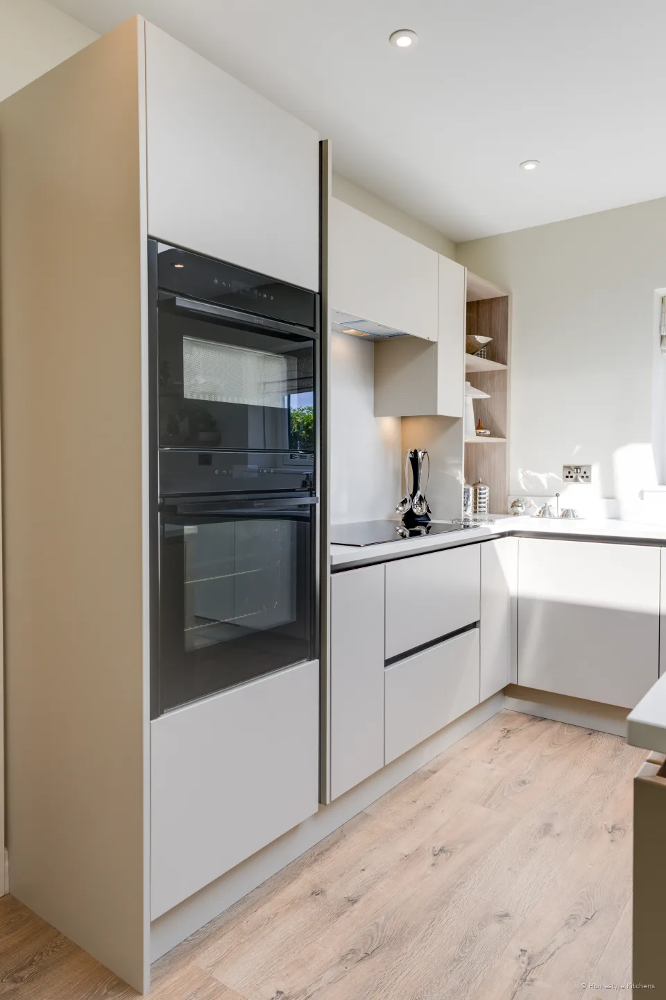 Tall oven housing in cream and mocha, black glass oven doors.