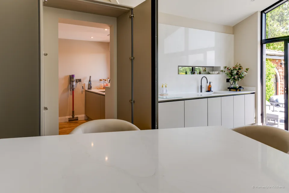 Pale grey island edge and glazing out to the garden.