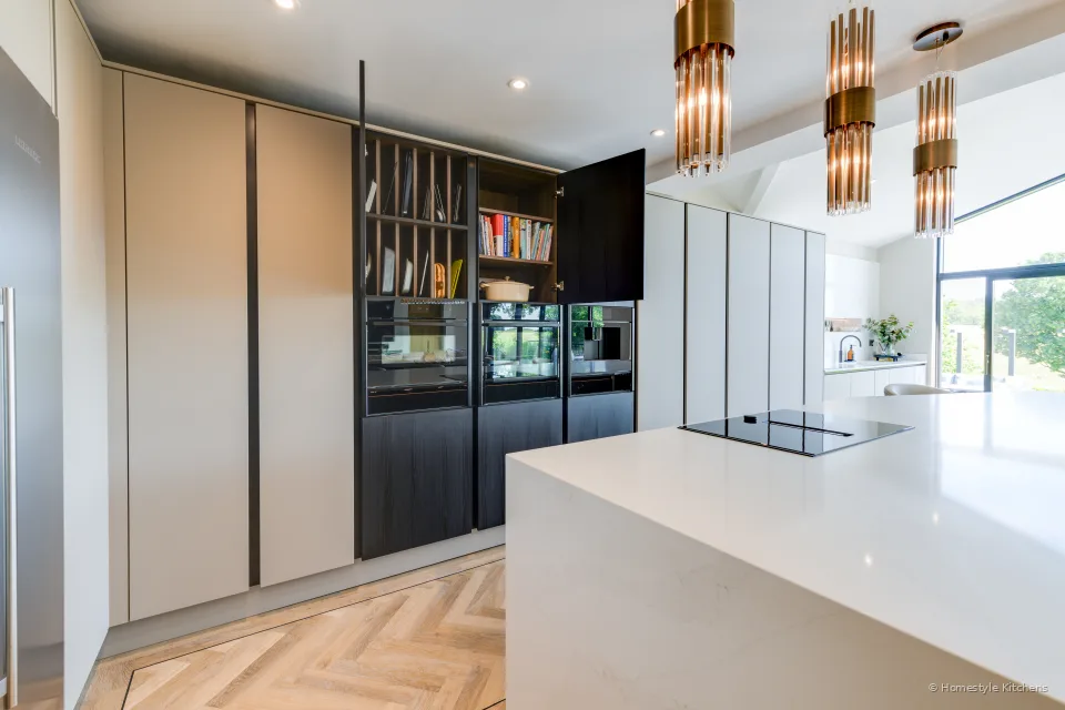Dark wood-grain tall cabinet open as a drinks cupboard, brass handles inside.