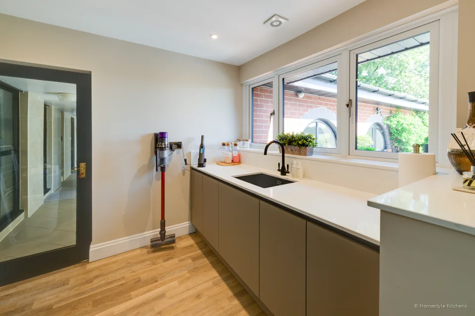 Utility run under windows, black tap, doorway to the hall.